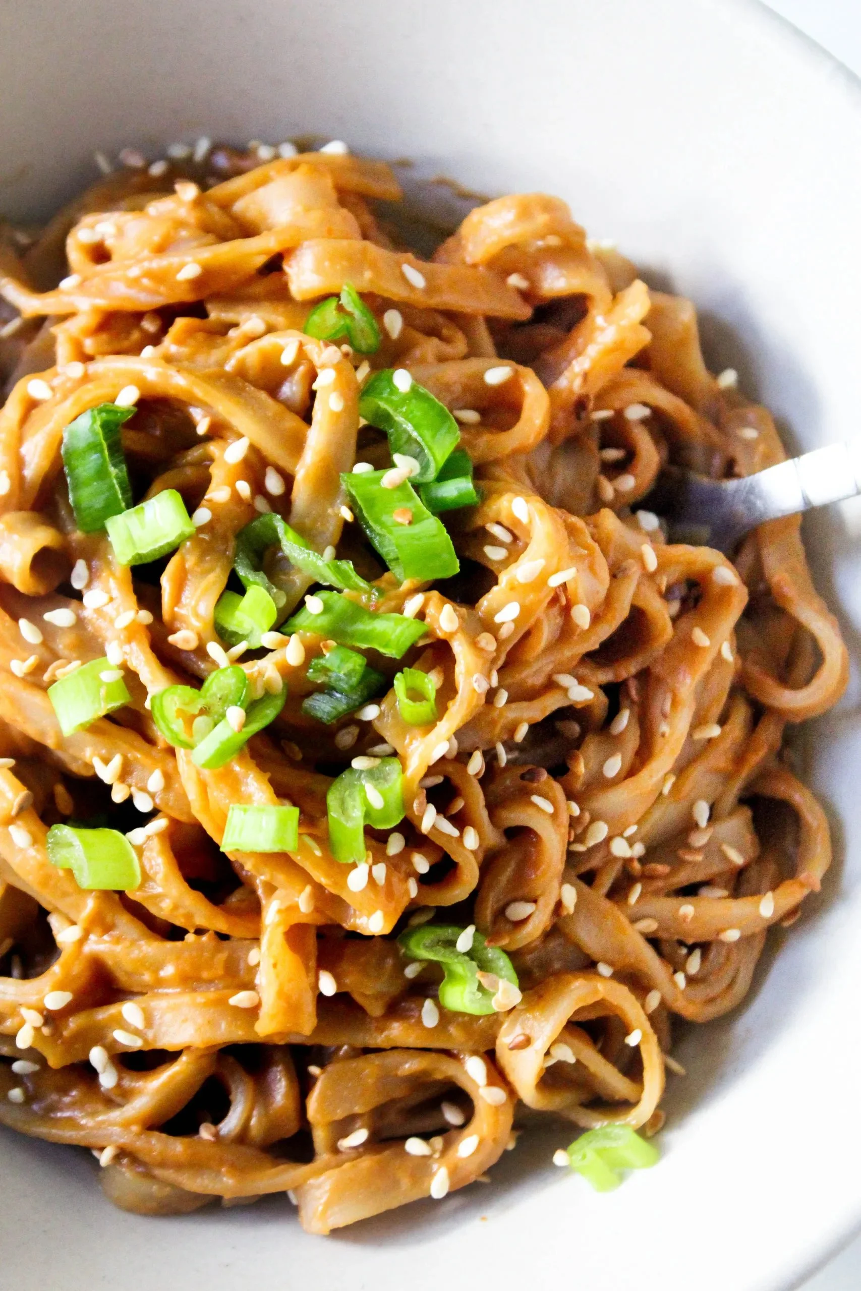 A bowl of rice noodles topped with quick homemade peanut sauce.