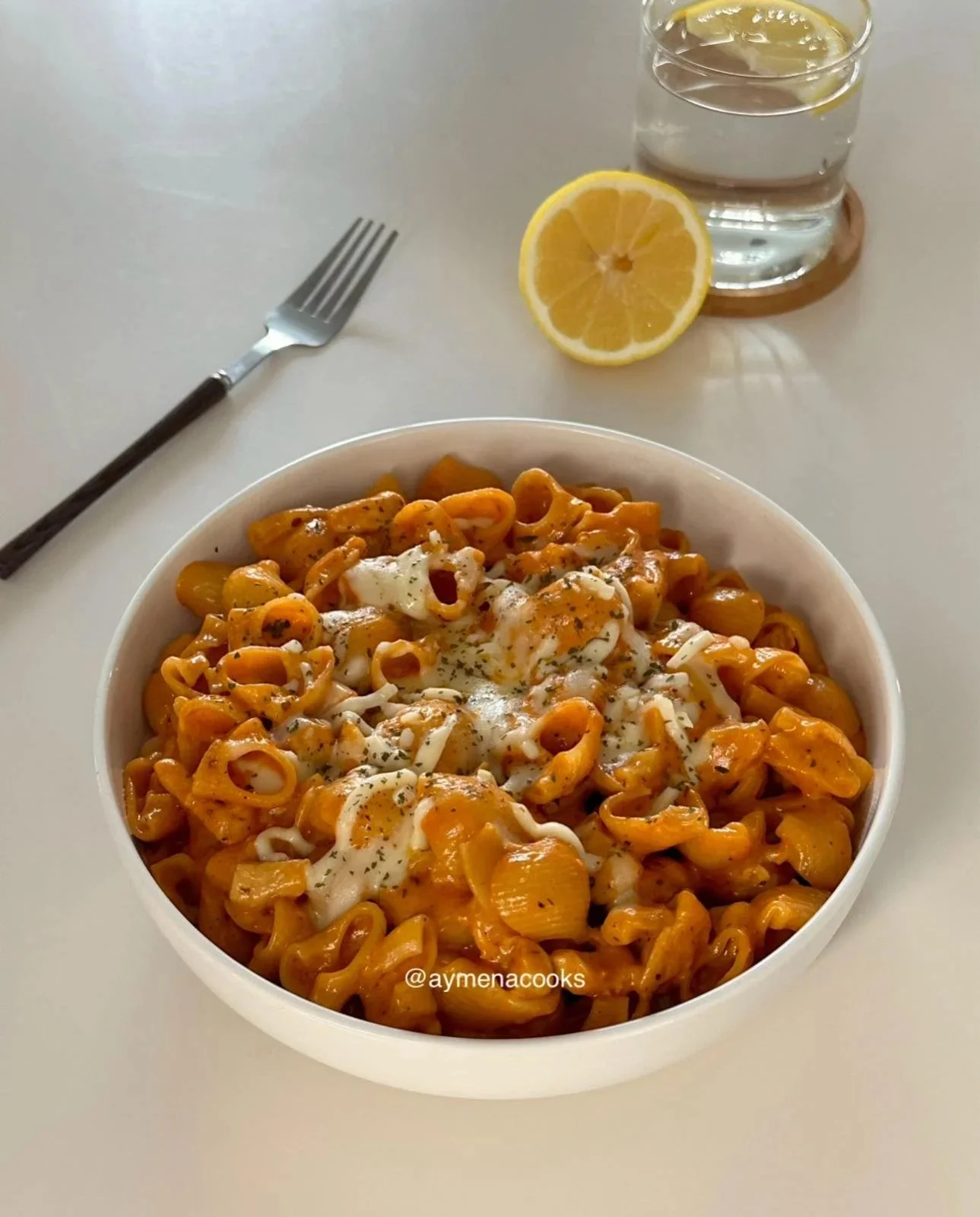 Delicious Cheesy Chicken Pasta topped with melted cheese and herbs