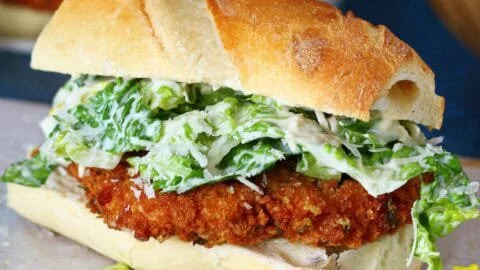 Crispy Chicken Caesar Sandwich with lettuce and Caesar dressing on a toasted bun