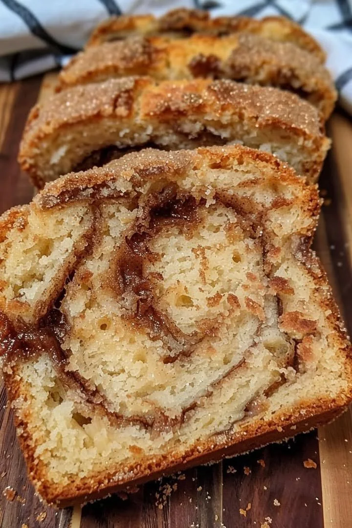 Freshly baked cinnamon bread with a golden crust and cinnamon swirl.