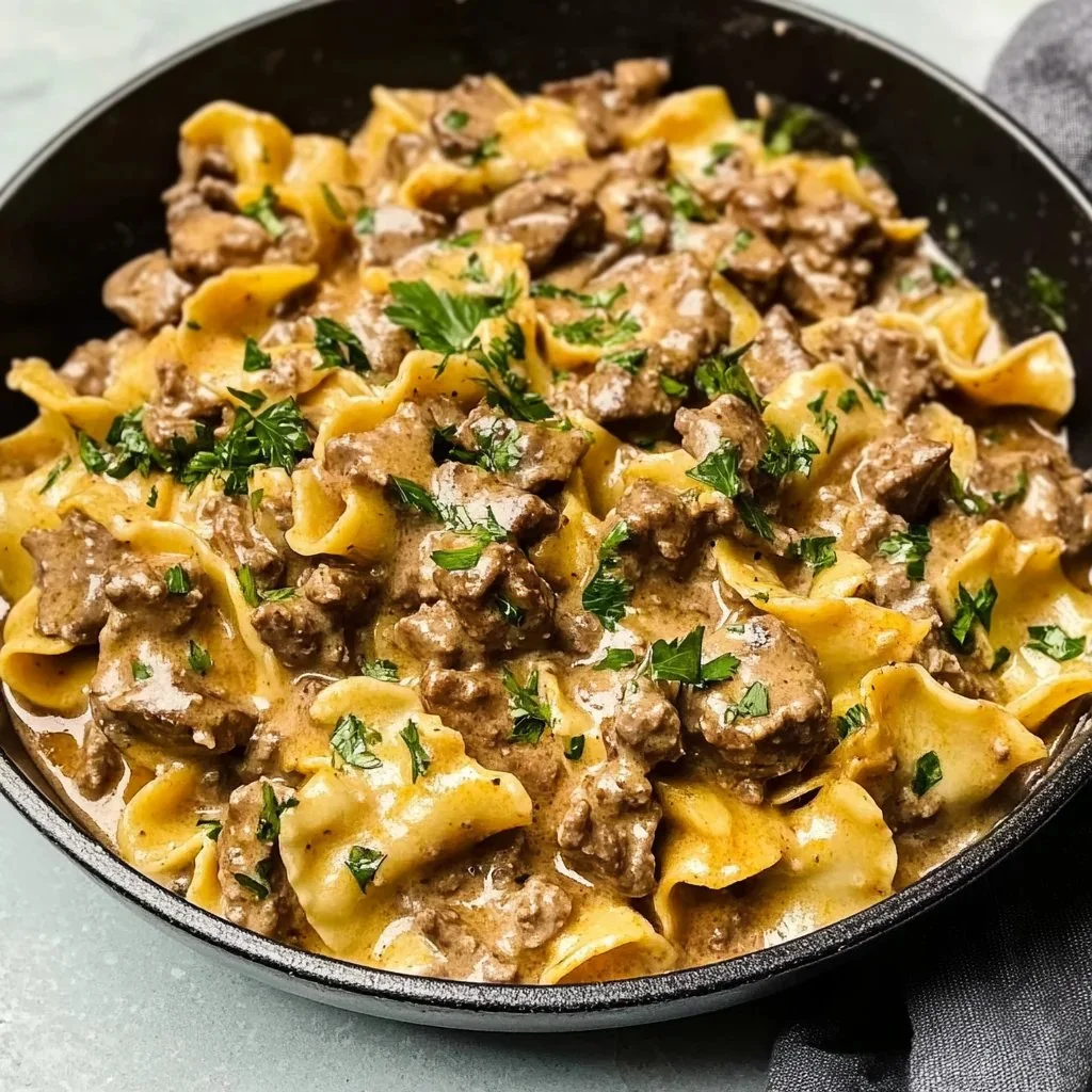 Delicious Ground Beef Stroganoff served with pasta and garnished with parsley