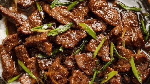 Delicious plate of Mongolian Beef served with vegetables and rice.