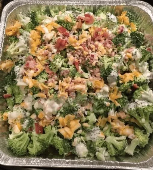Delicious and vibrant broccoli salad topped with nuts and dressing